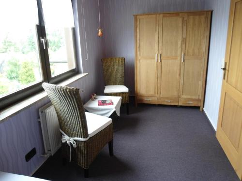 a room with two chairs and a table and a window at Haus Fernblick in Bad Grund