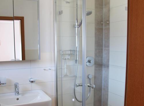 a bathroom with a shower and a sink at Gästehaus Reutemann in Nonnenhorn