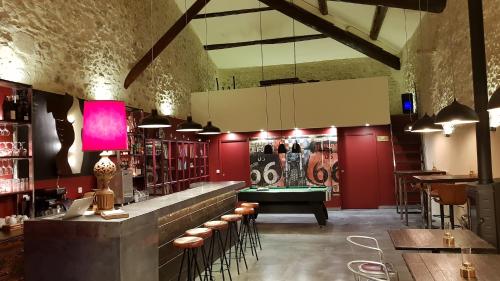 a bar with a pool table in a room at Domaine De Pradaous in Reillanne