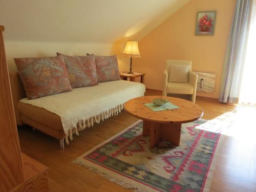 a living room with a couch and a table at Ferienwohnungen Margreiter in Mitterbach
