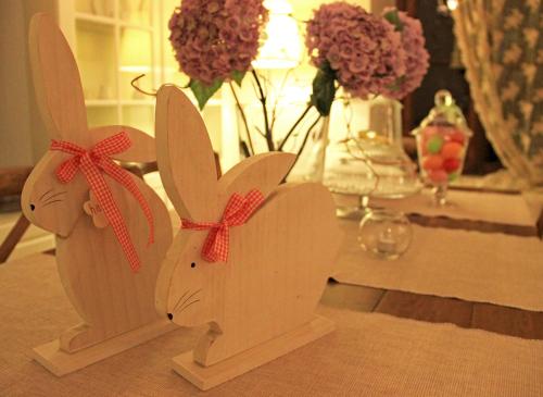 two wooden bunnies sitting on a table with flowers at Boutique Hotel Kentrikon & Bungalows in Agios Ioannis Pelio