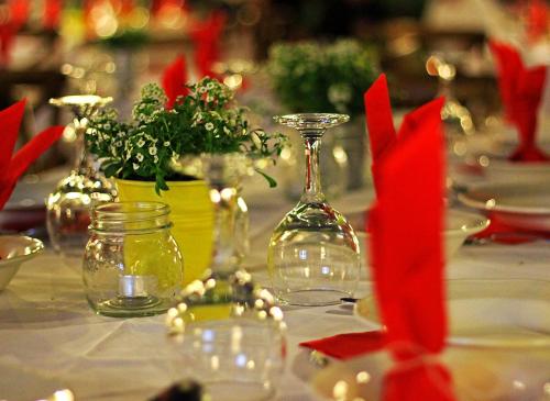 a table with wine glasses and potted plants on it at Boutique Hotel Kentrikon & Bungalows in Agios Ioannis Pelio