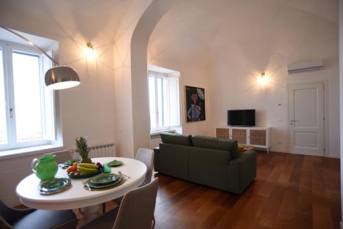 a living room with a couch and a table at Suite Calderini in Perugia