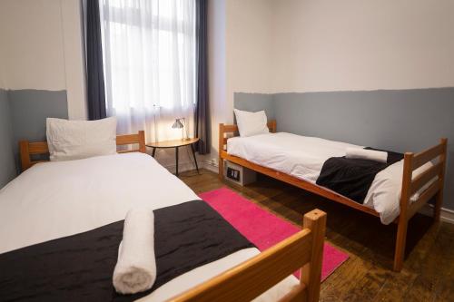 a bedroom with two beds and a window at Rossio Hostel in Lisbon