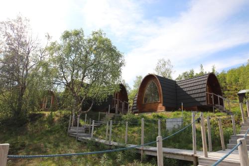 a house in the middle of a field with trees at Snowhotel Kirkenes in Kirkenes