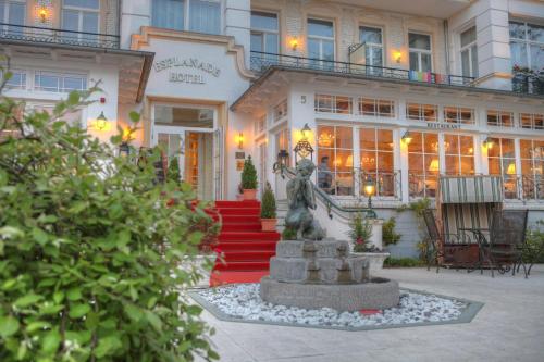 a statue of a horse in front of a building at SEETELHOTEL Hotel Esplanade mit Villa Aurora in Heringsdorf