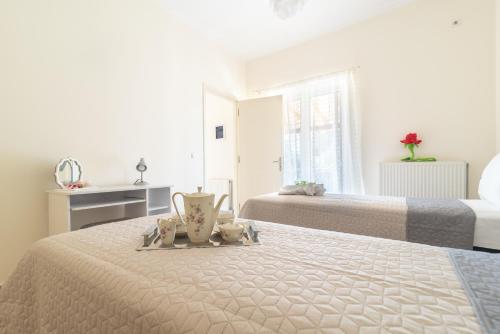 a bedroom with two beds and a tray on a bed at VILLA ELENI in Zakharo