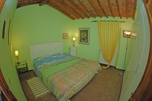a bedroom with a bed in the corner of a room at Agriturismo I Poggi in Impruneta