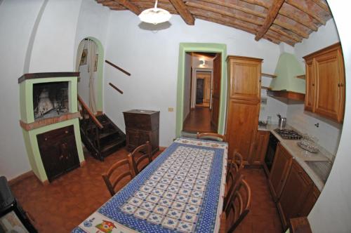 a dining room with a table and a kitchen at Agriturismo I Poggi in Impruneta
