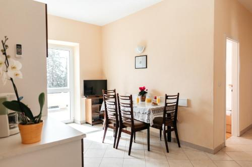 a dining room with a table and chairs at Apartments Tudić in Brodarica