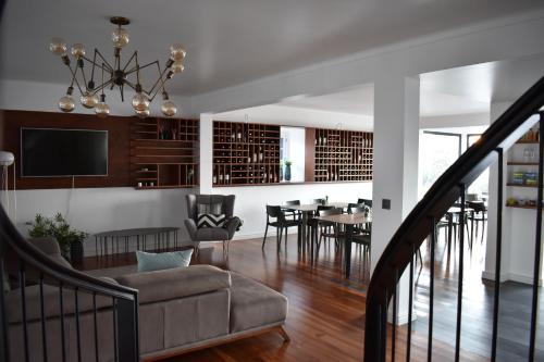 a living room with a couch and a dining room at Volcanic Charming House in Ribeira Grande