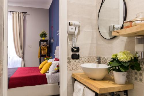 a bathroom with a sink and a bed in a room at B&B i Maestri in Naples
