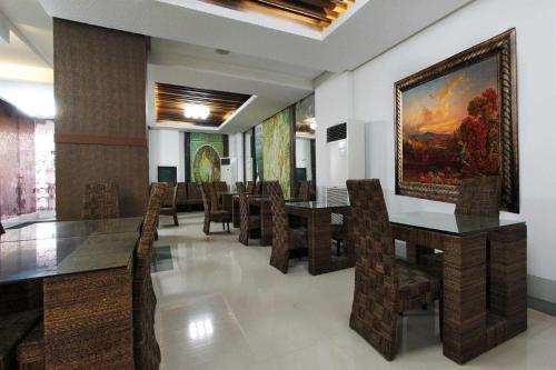 
a living room filled with furniture and a painting on the wall at Eurotel Boracay in Boracay
