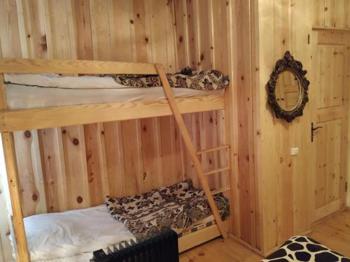 a room with two bunk beds in a cabin at Ecohouse Svaneti in Mestia