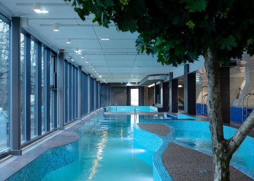 a swimming pool with blue walls and a blue ceiling at Kalev Spa Hotel & Waterpark in Tallinn