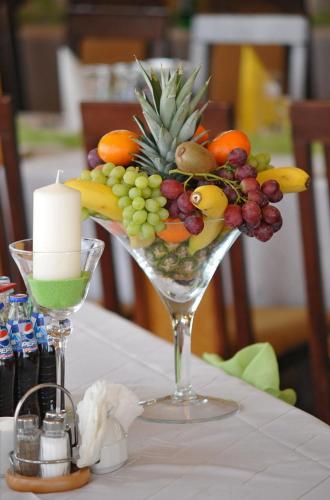 a glass vase filled with fruit and a candle on a table at Skalny Dworek in Nowy Targ