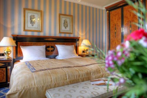 a bedroom with a bed with two tables and two lamps at SEETELHOTEL Ahlbecker Hof das elegante Traditionshotel & ruhiger Rückzugsort an der Ostsee in Ahlbeck