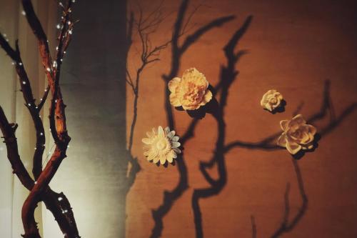 a painting of flowers on a tree branch at GOIN Old House & Bar in Tainan