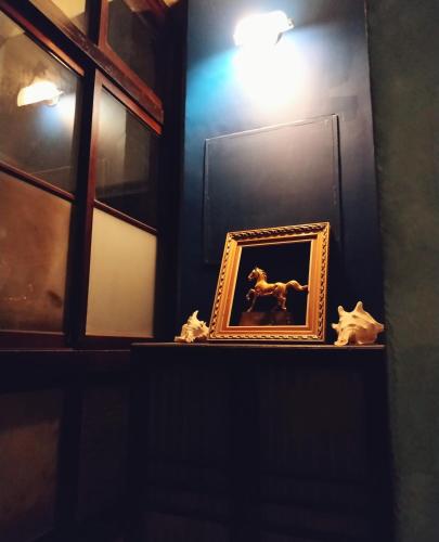 a picture in a frame on a shelf with lights at GOIN Old House & Bar in Tainan
