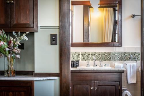 a bathroom with a sink and a mirror at Ballina Manor Boutique Hotel in Ballina