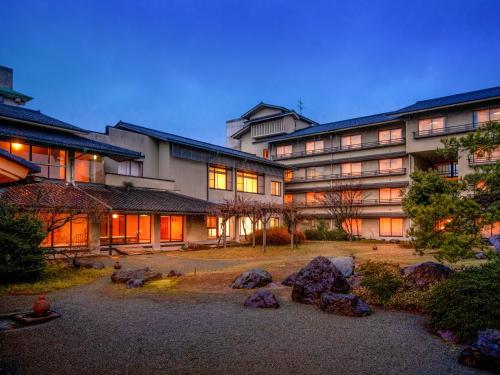 a large building with rocks in front of it at Awara Onsen Minoya Taiheikaku in Awara