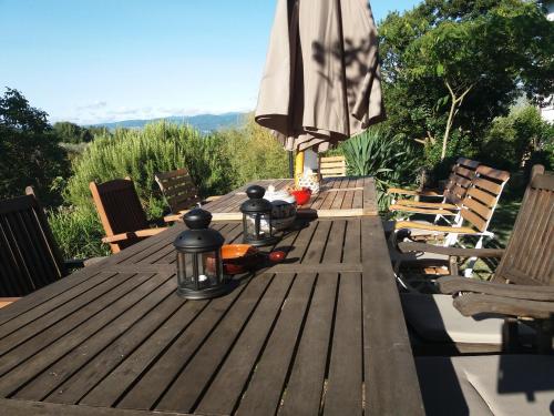a wooden table with chairs and an umbrella at Borgo San Michele Incisa Tuscany in Incisa in Valdarno