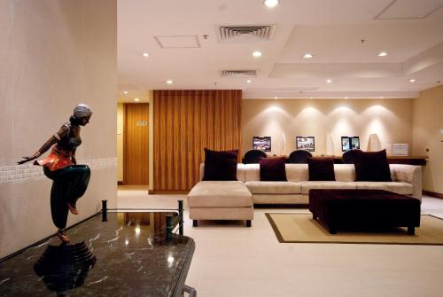 a woman is standing on a table in a living room at BEST WESTERN PLUS Hotel Hong Kong in Hong Kong
