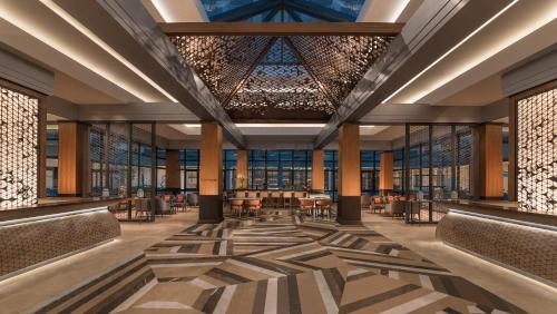 a rendering of the lobby of a hotel with tables and chairs at dusitD2 Davao in Davao City