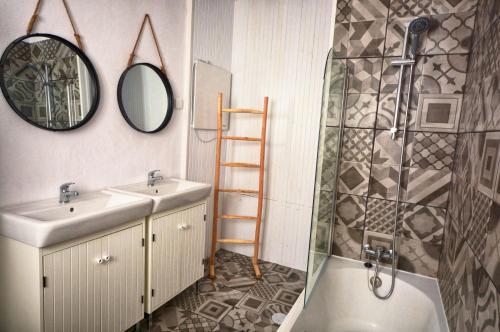 a bathroom with a sink and a shower and a mirror at Old Charming House Faro in Faro