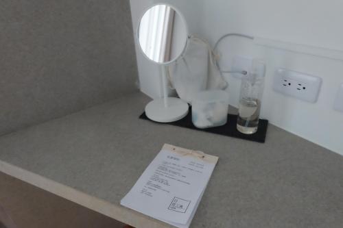 a table with a lamp and a mirror on it at Lof/it in Taitung City