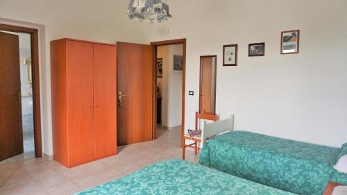 a bedroom with two beds and a chandelier at Agriturismo Costa San Bernardo in Vaglio di Basilicata