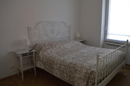 a bedroom with a bed and a table and a window at Casa Vacanze Matilda in Varazze