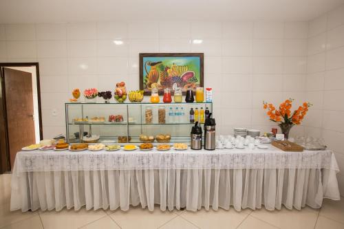 a table with plates of food on it at Recanto Hotel Clube in Caetité