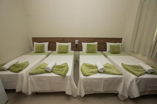 Säng eller sängar i ett rum på Recanto Hotel Clube