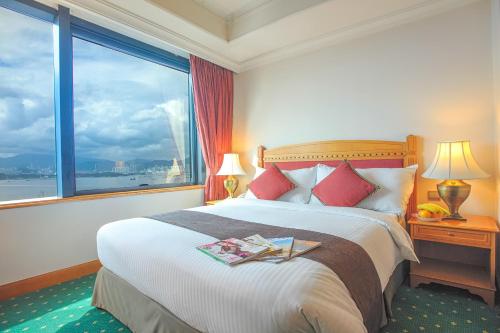 a bedroom with a large bed with a large window at BEST WESTERN PLUS Hotel Hong Kong in Hong Kong