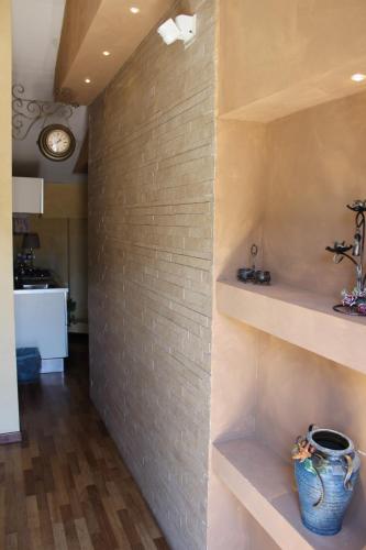 a brick wall with shelves and a vase on it at Centro Storico in Foggia