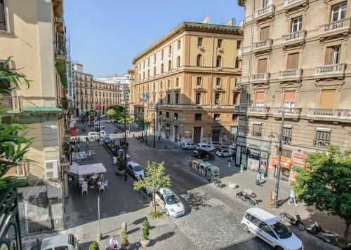 a view of a city street with cars and buildings at il faro di serapide in Naples