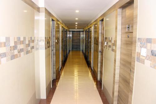 a hallway of elevators in a building at Vinayaga by Poppys ,Kumbakonam in Kumbakonam