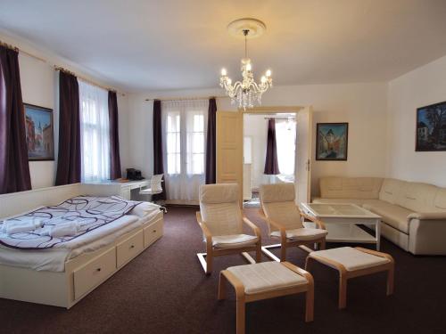 a bedroom with a bed and a living room at Apartmány Tábor in Tábor