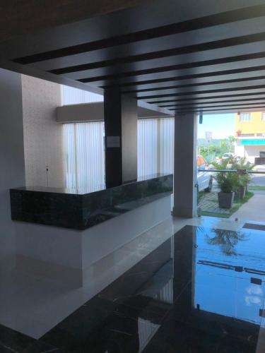 a lobby of a building with a reflection in the water at Flat de luxo em Lagoa Santa/MG in Lagoa Santa