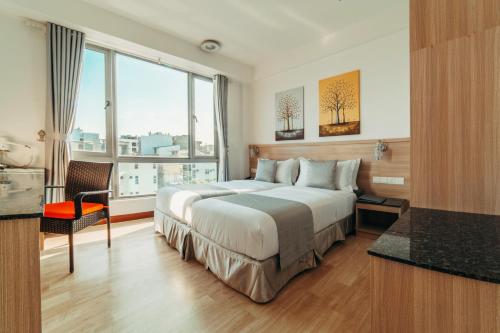 a hotel room with a bed and a large window at Paralian Hulhumale' in Hulhumale