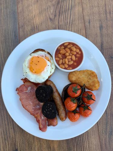 a plate of breakfast food with eggs bacon beans and toast at The Royal Oak in Loughborough