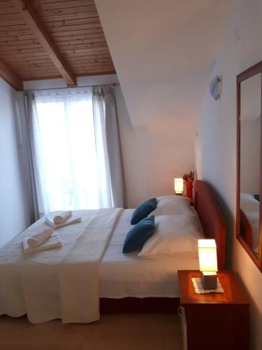 a bedroom with a bed with two towels on it at Mala Basina -Maslina in Vrbanj