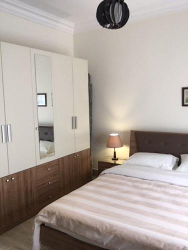 a bedroom with a bed and a dresser and a mirror at El-Shorouk Housing gate2 in Cairo