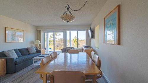 a living room with a table and a couch at Sea Crest in Amagansett