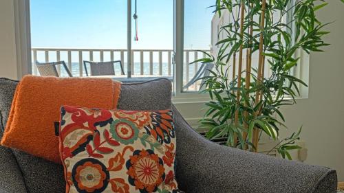 a living room with a couch and a pillow at Sea Crest in Amagansett