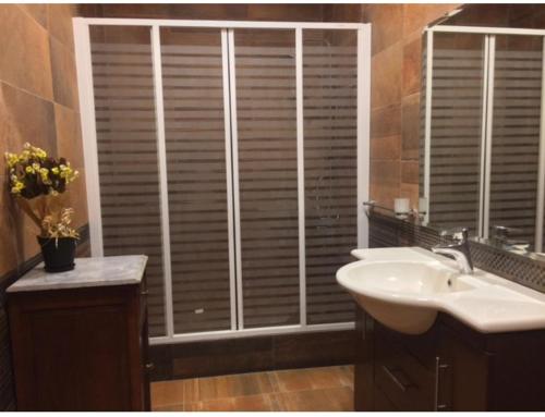 a bathroom with a sink and a window with blinds at El-Shorouk Housing gate2 in Cairo