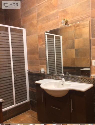 a bathroom with a sink and a mirror at El-Shorouk Housing gate2 in Cairo