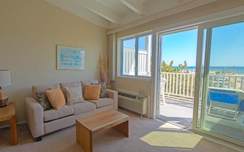 a living room with a couch and a view of the ocean at Sea Crest in Amagansett