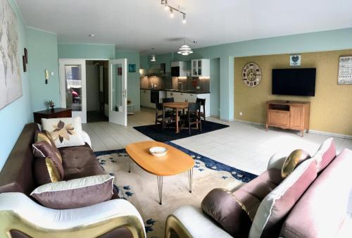 a living room with two couches and a table at Renovated Apartment in Antwerp city center in Antwerp